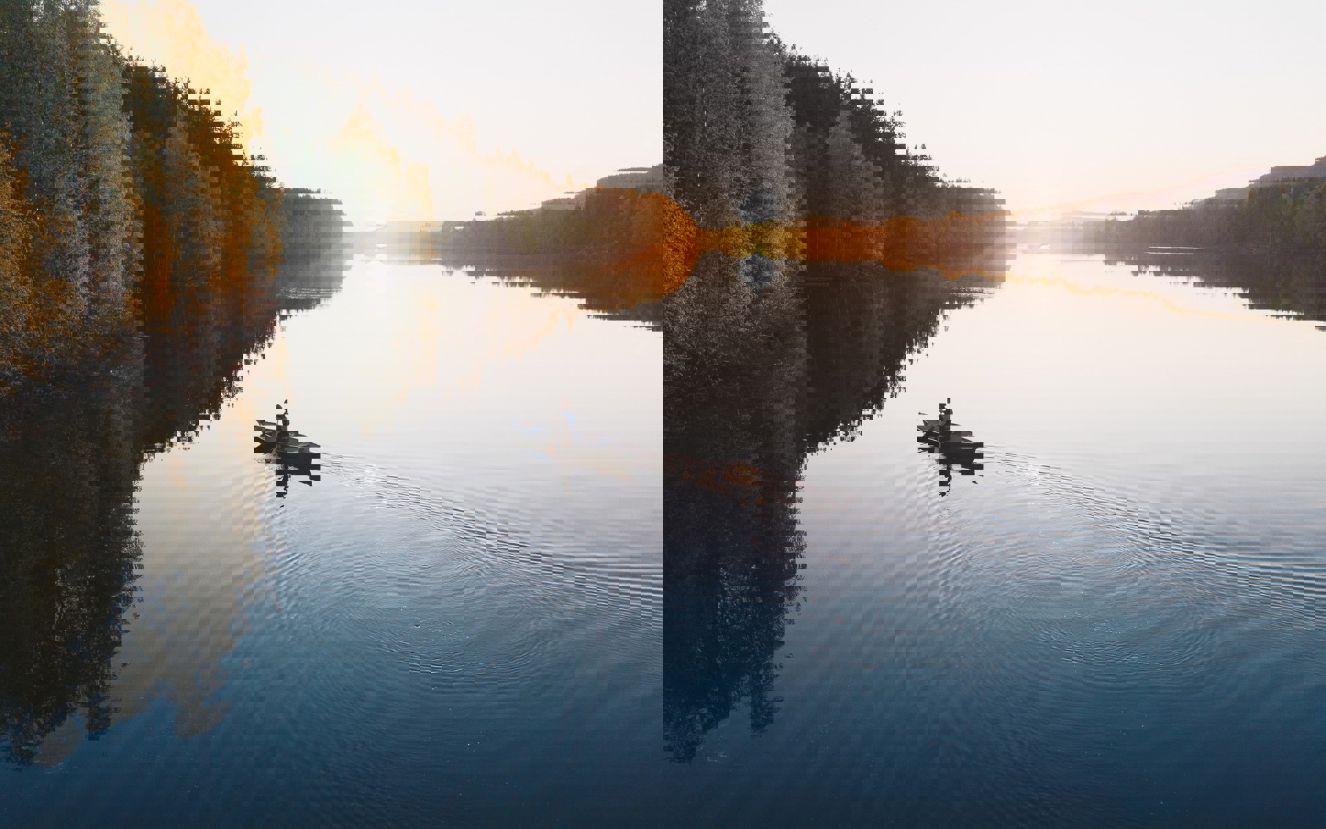 A person in a canot in sunset. 